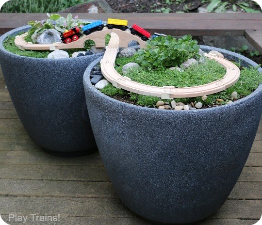 Toy Train garden in flower pots! Creative ways to add color and joy to a garden, porch, or yard with DIY Yard Art and Garden Ideas! Repurposed ideas for the backyard. Fun ideas for flower gardens made from logs, bikes, toys, tires and other old junk. ~ featured at LivingLocurto.com