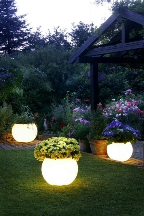 Glow in the dark flower planters! Creative ways to add color and joy to a garden, porch, or yard with DIY Yard Art and Garden Ideas! Repurposed ideas for the backyard. Fun ideas for flower gardens made from logs, bikes, toys, tires and other old junk. ~ featured at LivingLocurto.com