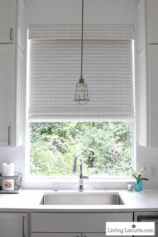 New White Kitchen Reveal. Amazing before and after photos of a modern farmhouse style kitchen home remodel. Home decorating and kitchen inspiration. Stainless Steel Sink and Cage Industrial Lighting. LivingLocurto.com