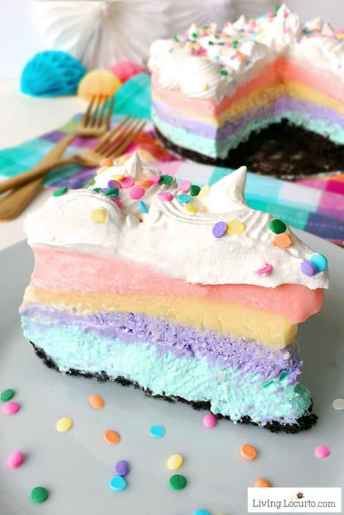 An easy no bake Unicorn Poop Lasagna dessert recipe! Fluffy pastel rainbow pie with layers of cheesecake, pudding and Cool Whip on a chocolate Oreo crust. 