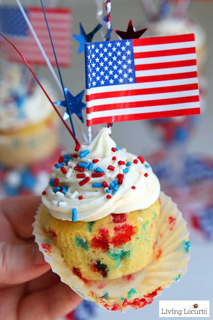 Easy Red, White and Blue Funfetti Cupcakes recipe for a 4th of July party. Display in plastic wine glasses filled with patriotic candy for a fun wow factor! These simple cupcakes are filled with patriotic colors and topped with homemade buttercream icing, sprinkles and American Flags. 