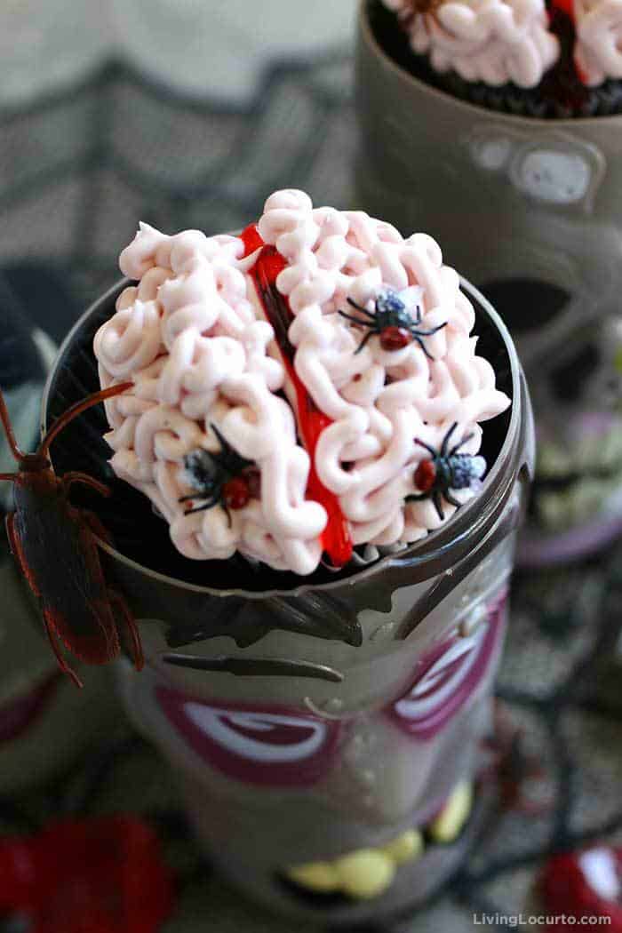 Creepy Brain Cupcakes covered in flies and other bugs.