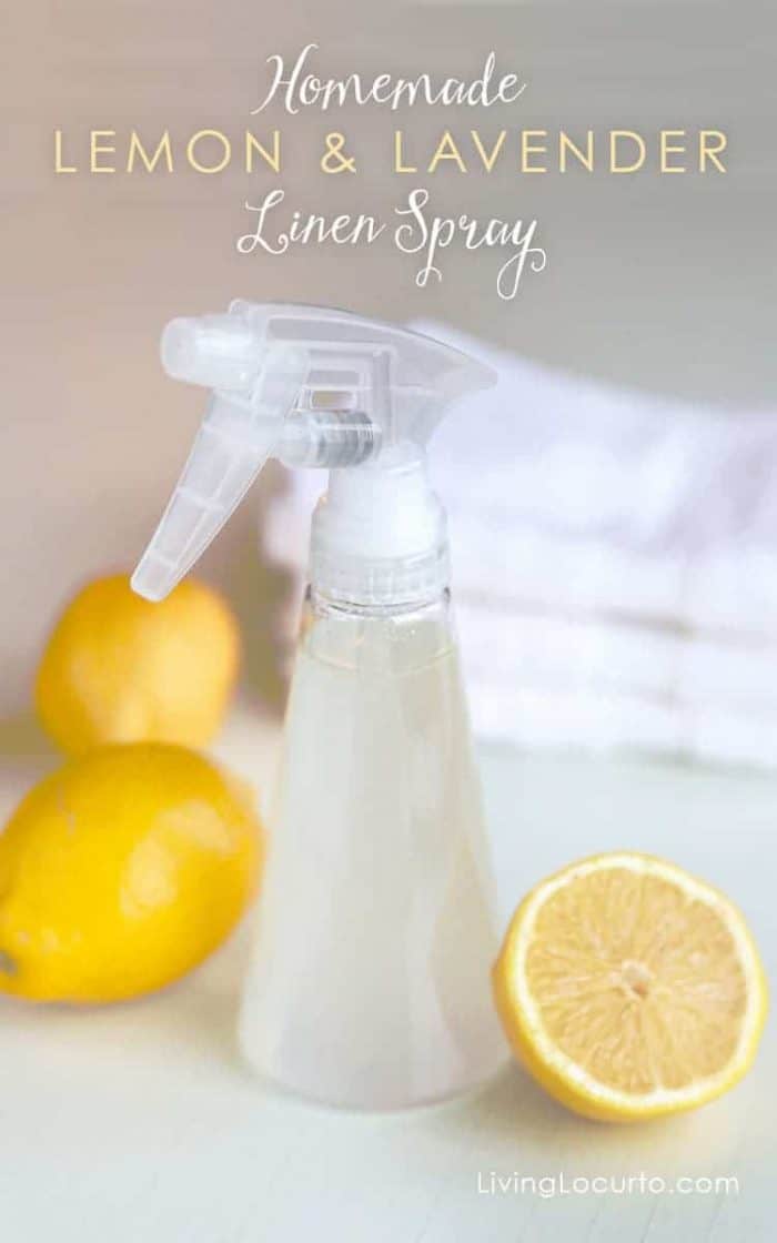 Homemade Lemon and Lavender Linen Spray. A white spray bottle is pictured with cut lemons surronding it.