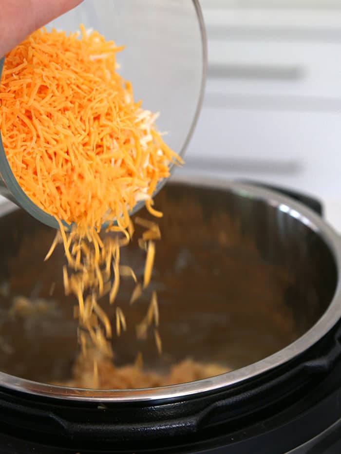 Instant Pot mixing cheese to make Mac and Cheese
