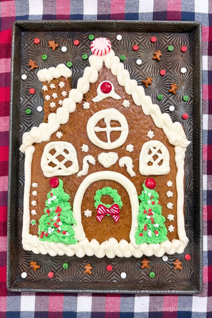 Easy Gingerbread House Cake 2 The cutest Gingerbread House Cake with a simple boxed-mix upgrade! This sweet and festive cake is shaped like a gingerbread house and decorated with easy frosting details.