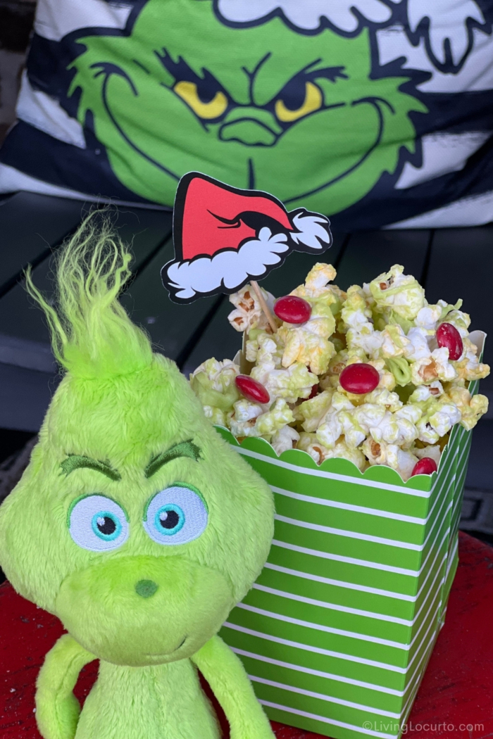 An easy no-bake holiday snack made with popcorn, green candy melts, and red candies.