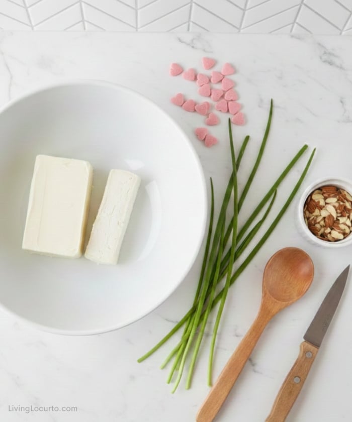 The Purr-fect Cat Cheeseball 3 asy Cat Cheeseball Recipe Ingredients. Bowl of cheese and other items on a white countertop.