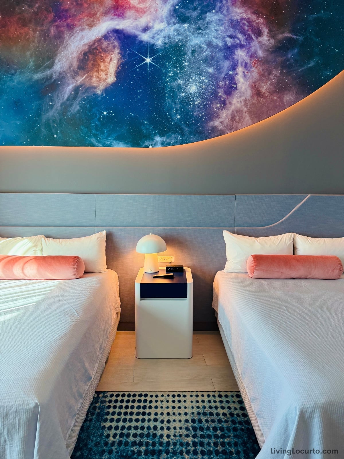 Modern hotel room with cosmic mural.