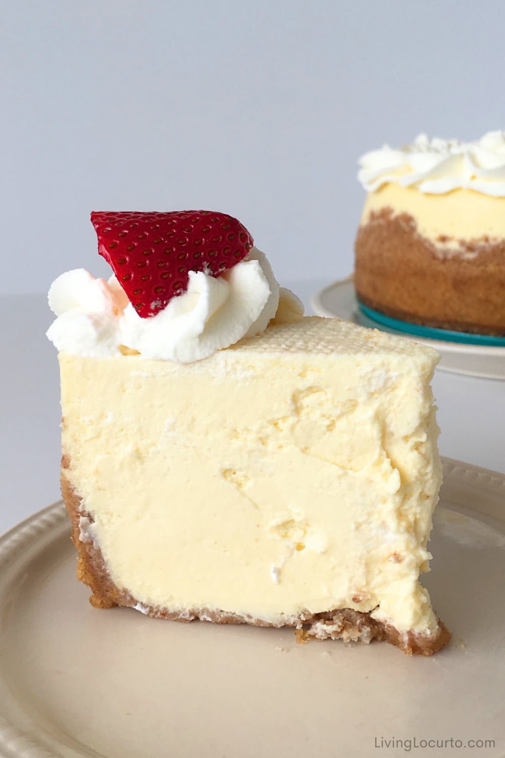 Copycat Cheesecake Factory Cheesecake 3 Cheesecake Slice with strawberry and whipped cream topping.